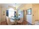 Elegant dining room with vaulted ceiling, modern table setting, and ample natural light at 5291 Nw 20 Pl, Ocala, FL 34482