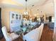 Bright dining room boasts hardwood floors, vaulted ceilings, and flows into an open-concept kitchen at 5291 Nw 20 Pl, Ocala, FL 34482