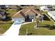 Beautiful single-story home with a well-manicured lawn, large driveway, and a charming front entrance at 5291 Nw 20 Pl, Ocala, FL 34482