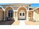 Welcoming front entrance with arched details, columns, and a charming brick walkway at 5291 Nw 20 Pl, Ocala, FL 34482