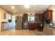 Well-lit kitchen offers stainless steel appliances, granite counters, and tile flooring at 5291 Nw 20 Pl, Ocala, FL 34482