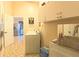 Functional laundry room boasts a sink, washer, dryer, ample cabinet space, and stylish Porto Ramos-Pinto decor at 5291 Nw 20 Pl, Ocala, FL 34482