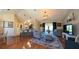 Open-concept living area featuring stylish furnishings, hardwood flooring, and seamless flow into the kitchen at 5291 Nw 20 Pl, Ocala, FL 34482