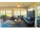 Inviting living area with comfortable seating, hardwood floors, and ample natural light from large windows at 5291 Nw 20 Pl, Ocala, FL 34482