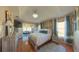 Bright main bedroom boasts hardwood floors, ample natural light, and comfortable bed at 5291 Nw 20 Pl, Ocala, FL 34482