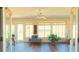 Bright sunroom featuring hardwood floors, a ceiling fan, and large windows offering ample natural light at 5291 Nw 20 Pl, Ocala, FL 34482