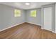 Bright bedroom features wood-look flooring, and natural light from two windows at 5311 Nw 27Th Ave, Ocala, FL 34475