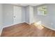 Bright bedroom featuring wood floors, neutral paint, and closet with natural light from the window at 5311 Nw 27Th Ave, Ocala, FL 34475