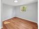 Bright bedroom with wood-look flooring and ample natural light from a large window at 5311 Nw 27Th Ave, Ocala, FL 34475