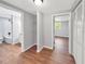 Hallway featuring storage shelves and a walk-in closet leading to the bathroom and bedroom at 5311 Nw 27Th Ave, Ocala, FL 34475