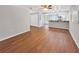 Spacious living area featuring wood floors, an adjacent kitchen and a ceiling fan at 5311 Nw 27Th Ave, Ocala, FL 34475