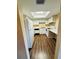 Bright kitchen with white appliances and cabinets, wood flooring, and a skylight providing natural light at 584 Bahia Cir # B, Ocala, FL 34472