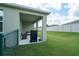 This home features a covered patio and spacious backyard with well-maintained lawn at 6138 Sw 89Th Lane Rd, Ocala, FL 34476