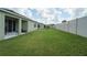 Spacious backyard featuring lush green grass and a tall white fence, perfect for outdoor activities at 6138 Sw 89Th Lane Rd, Ocala, FL 34476