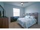 This bedroom features a ceiling fan, a window, and a comfortable bed with stylish bedding at 6138 Sw 89Th Lane Rd, Ocala, FL 34476