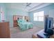 Bright bedroom featuring a ceiling fan, tray ceiling and a large window at 6138 Sw 89Th Lane Rd, Ocala, FL 34476