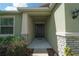 Close-up of the home's entrance featuring a stylish front door and stone accents at 6138 Sw 89Th Lane Rd, Ocala, FL 34476