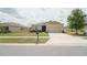 Inviting single-story home with a two-car garage and lush front lawn at 6138 Sw 89Th Lane Rd, Ocala, FL 34476