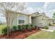 Landscaped front yard with garden and covered entry on this delightful home at 6138 Sw 89Th Lane Rd, Ocala, FL 34476