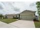 This beautiful home has an attached two-car garage and manicured lawn at 6138 Sw 89Th Lane Rd, Ocala, FL 34476