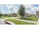 Well-maintained front yard with mature trees, lush green grass, and a concrete driveway at 6138 Sw 89Th Lane Rd, Ocala, FL 34476