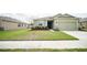 Charming home featuring a well-manicured lawn and colorful garden beds, enhancing its curb appeal at 6138 Sw 89Th Lane Rd, Ocala, FL 34476