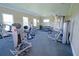 Well-equipped gym featuring multiple weight machines, free weights, and ample natural light at 6138 Sw 89Th Lane Rd, Ocala, FL 34476