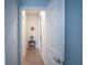 Inviting hallway features neutral paint, tile flooring, and doorway leading to additional rooms in the home at 6138 Sw 89Th Lane Rd, Ocala, FL 34476