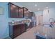Bright kitchen showcasing dark wood cabinetry, stainless appliances, and tile flooring at 6138 Sw 89Th Lane Rd, Ocala, FL 34476
