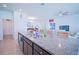 Open kitchen features a central island, granite countertops, stainless steel appliances, and ample space at 6138 Sw 89Th Lane Rd, Ocala, FL 34476
