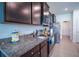 Well-equipped kitchen boasting dark cabinets, stainless steel appliances, and granite countertops at 6138 Sw 89Th Lane Rd, Ocala, FL 34476