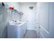 Bright laundry room features white appliances, storage shelves, and convenient access to the rest of the home at 6138 Sw 89Th Lane Rd, Ocala, FL 34476