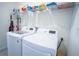 Close-up of laundry room featuring washer and dryer with overhead shelf at 6138 Sw 89Th Lane Rd, Ocala, FL 34476