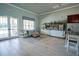 Inviting lounge area featuring comfortable seating, tile floors, and bright, fresh colors at 6138 Sw 89Th Lane Rd, Ocala, FL 34476
