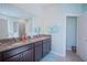 The bathroom features double sinks, granite countertops, and a doorway to the shower and tub at 6138 Sw 89Th Lane Rd, Ocala, FL 34476