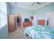Spacious bedroom with neutral walls, dresser, and open doorway into a walk-in closet at 6138 Sw 89Th Lane Rd, Ocala, FL 34476