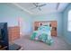 Serene main bedroom with tray ceilings, ceiling fan, and an en-suite bathroom at 6138 Sw 89Th Lane Rd, Ocala, FL 34476