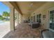 Spacious covered patio featuring comfortable seating, ceiling fans, and stunning waterfront views at 6138 Sw 89Th Lane Rd, Ocala, FL 34476