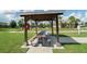 Covered picnic area with large table next to bocce ball court at 6138 Sw 89Th Lane Rd, Ocala, FL 34476