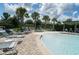 Sparkling community pool with surrounding lounge chairs and palm trees at 6138 Sw 89Th Lane Rd, Ocala, FL 34476