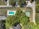 Aerial view of the community pool and shuffleboard court surrounded by lush greenery at 6398 Sw 108Th St, Ocala, FL 34476
