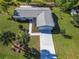 Aerial view of a single-story home featuring a well-maintained roof, spacious yard, and a lengthy driveway at 6398 Sw 108Th St, Ocala, FL 34476