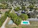 Aerial view showing the community clubhouse, pool, shuffleboard, and surrounding homes at 6398 Sw 108Th St, Ocala, FL 34476