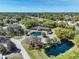 Aerial view of community clubhouse with ponds, lush trees, and surrounding neighborhood at 6398 Sw 108Th St, Ocala, FL 34476