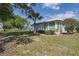 The backyard of the home is spacious with green grass and mature landscaping, backing to other homes at 6398 Sw 108Th St, Ocala, FL 34476