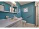 Standard bathroom featuring a tiled shower, integrated sink, and blue walls at 6398 Sw 108Th St, Ocala, FL 34476