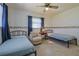 Comfortable bedroom with two twin beds, an armchair, and a floral wallpaper border at 6398 Sw 108Th St, Ocala, FL 34476