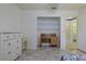 Bedroom featuring a desk, dresser, closet and an open doorway at 6398 Sw 108Th St, Ocala, FL 34476
