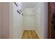 Walk-in closet featuring built-in shelving and laminate flooring at 6398 Sw 108Th St, Ocala, FL 34476