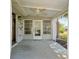 The covered patio with a ceiling fan provides an area to relax with easy access to the yard at 6398 Sw 108Th St, Ocala, FL 34476